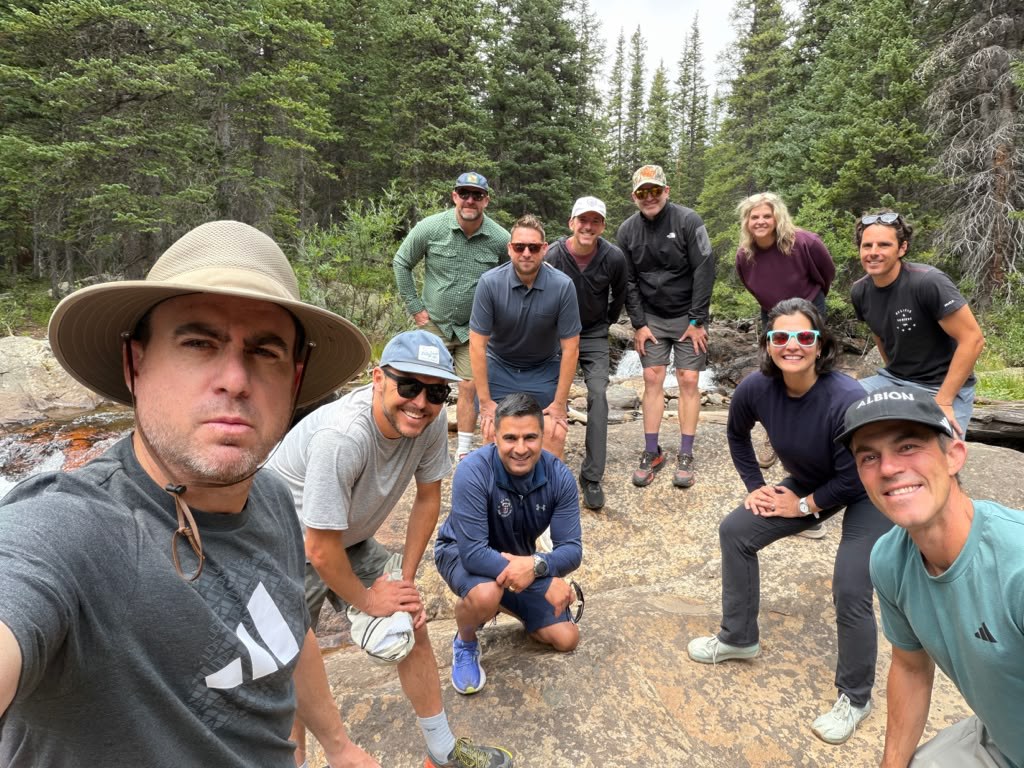 Group selfie of the board members on a mountain trail
